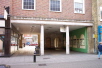 St Maurices Covert is a covered area much used for charity sales, demonstrations and exhibitions. At the back of this area is the church tower, with it's Norman gateway, the start of your tour.